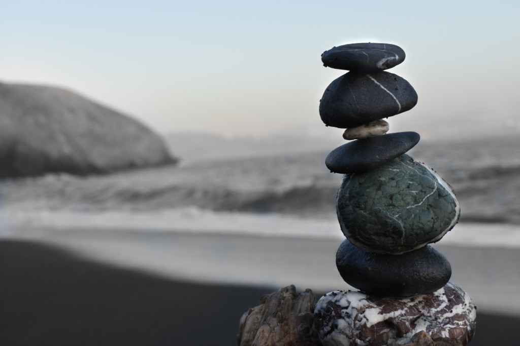 stack of rocks maintaining balance on the beach like we maintain work-life balance