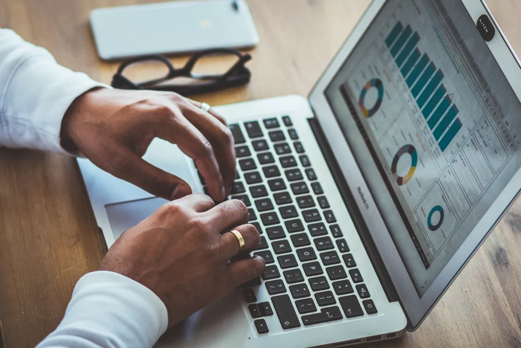 Person on laptop looking at Google Analytics information to check marketing trends