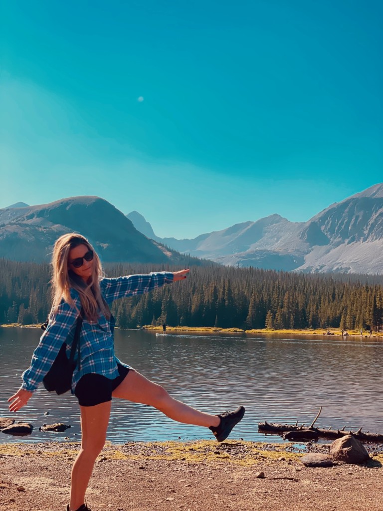 Crystal Coulson walking alongside a mountain lake