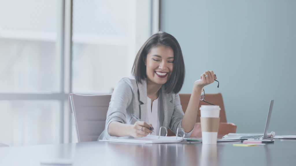 employee in board room smiling because of career satisfaction