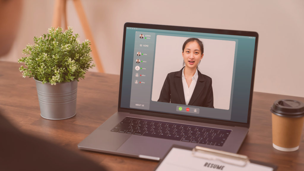laptop on desk showing a virtual interview video call