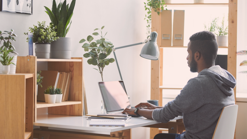 person on their laptop at their remote work setup