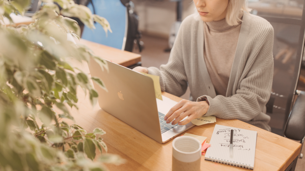 candidate at desk writing email with good email etiquette