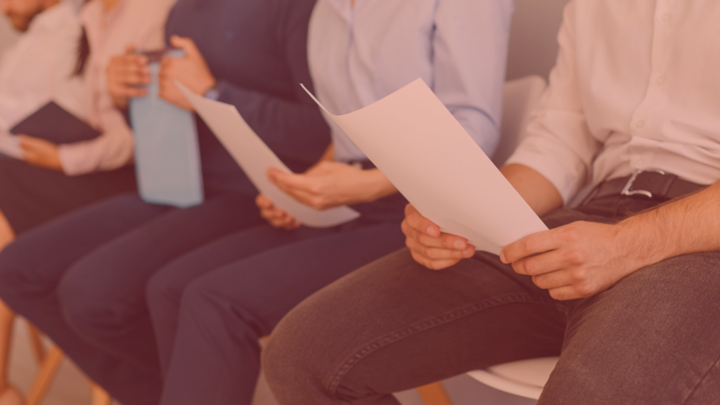 line of people holding their entry-level resume outside of an interview